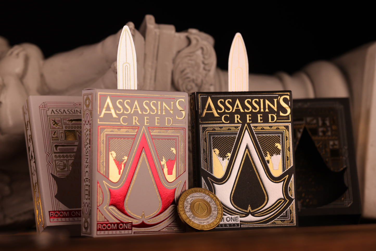 Assassin's Creed playing card bundle with decorative elements on a dark background