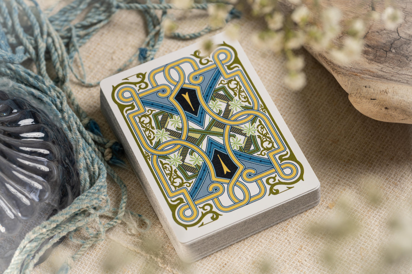 Playing card back with decorative design on a textured surface