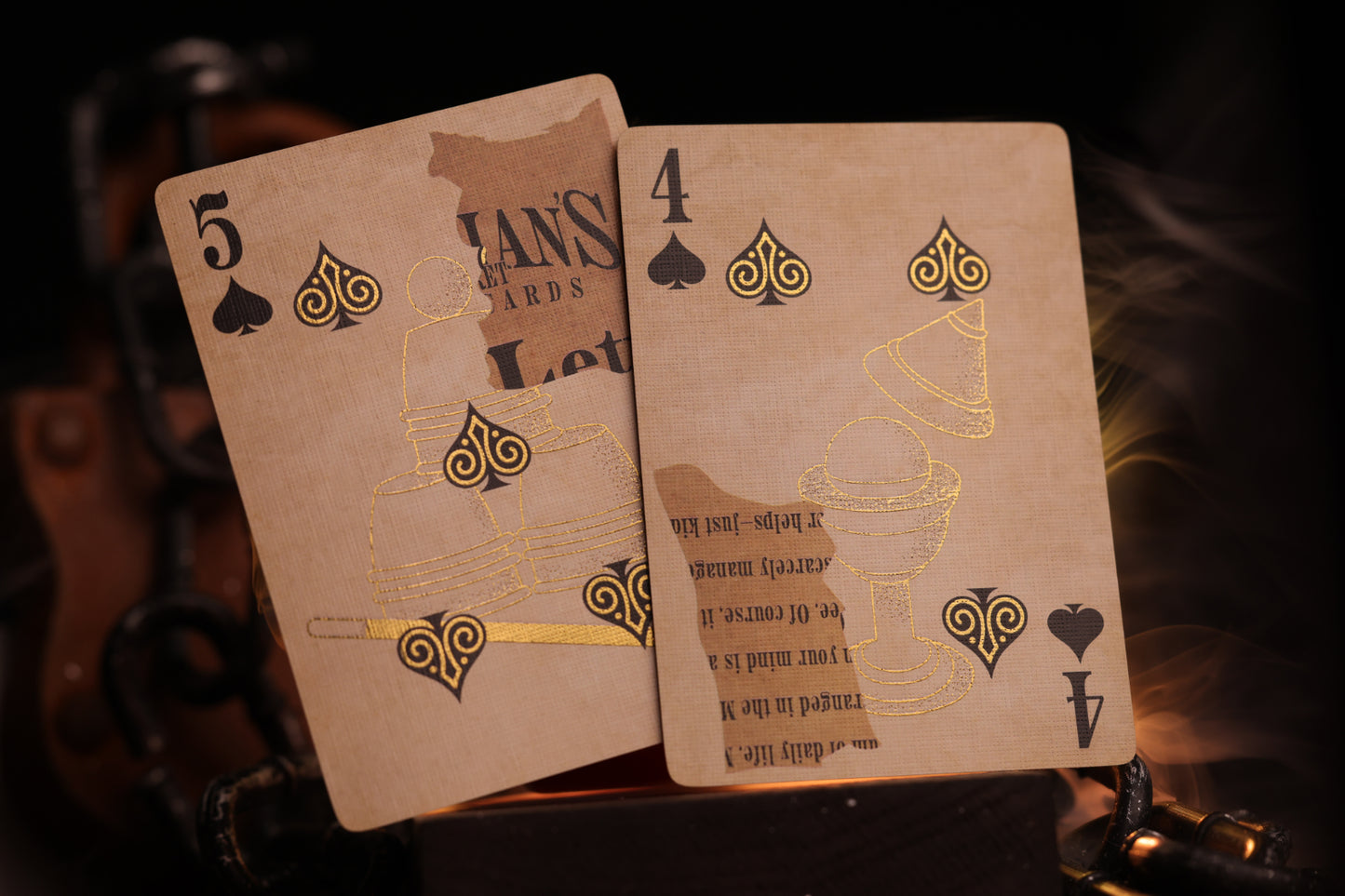 Two number cards with metallic gold cold foil detailing on a dark background