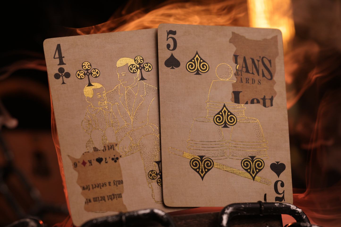 Two number cards with metallic gold cold foil detailing on a dark background