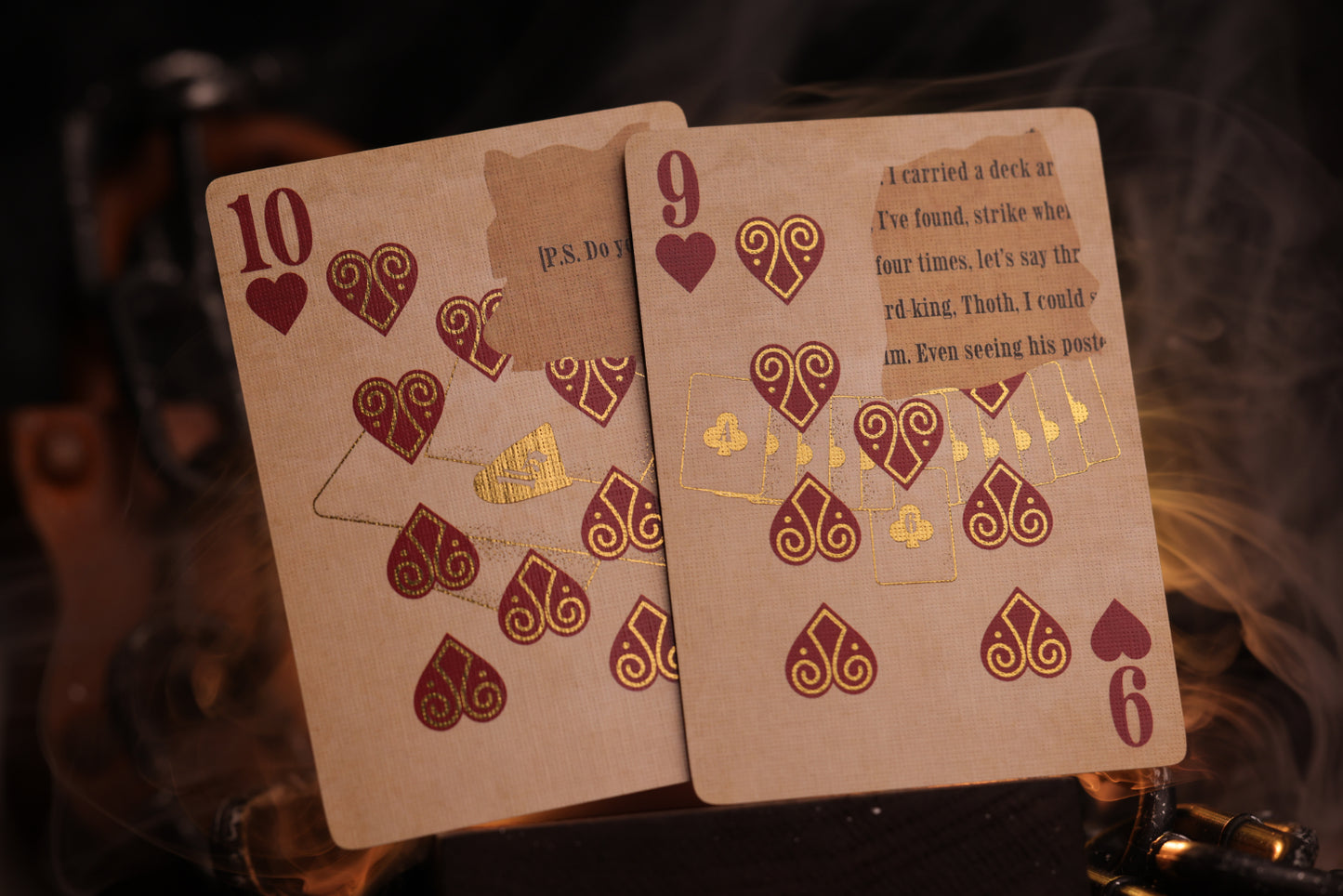 Two number cards with metallic gold cold foil detailing on a dark background