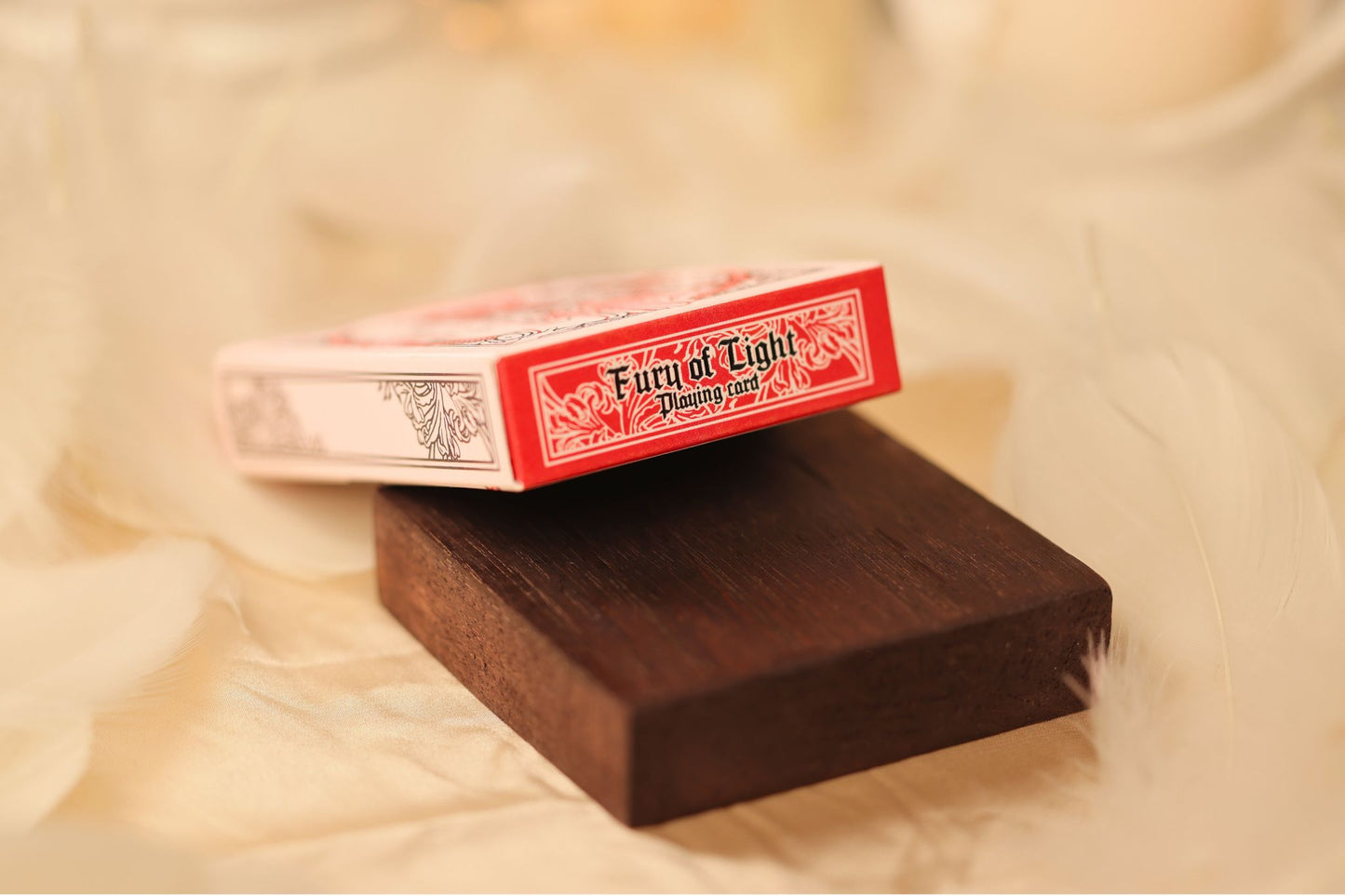 MYTHIC edition Fury of Light Tuck Box Detail with spider-lily design on a bed of feathers.