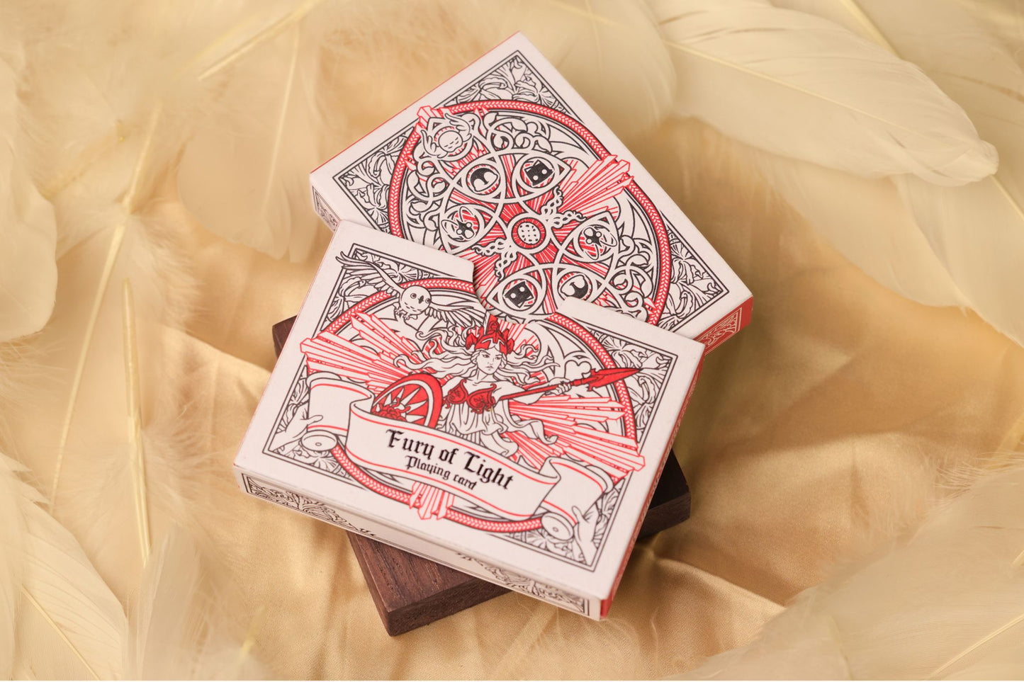 MYTHIC edition Fury of Light Tuck Box & Slipcase with an illustration of a goddess on a bed of feathers.