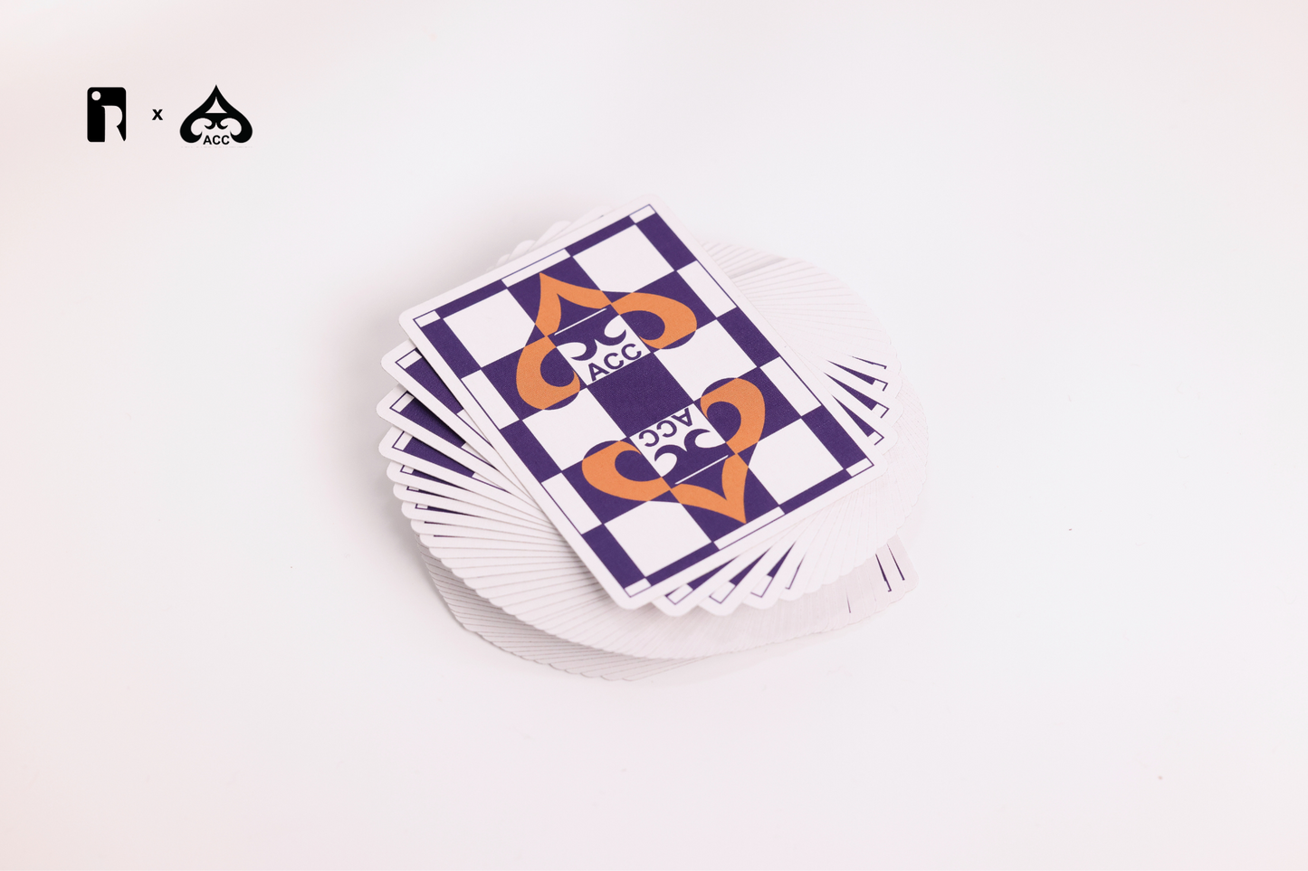 Stack of playing cards with a checkered design on a white surface