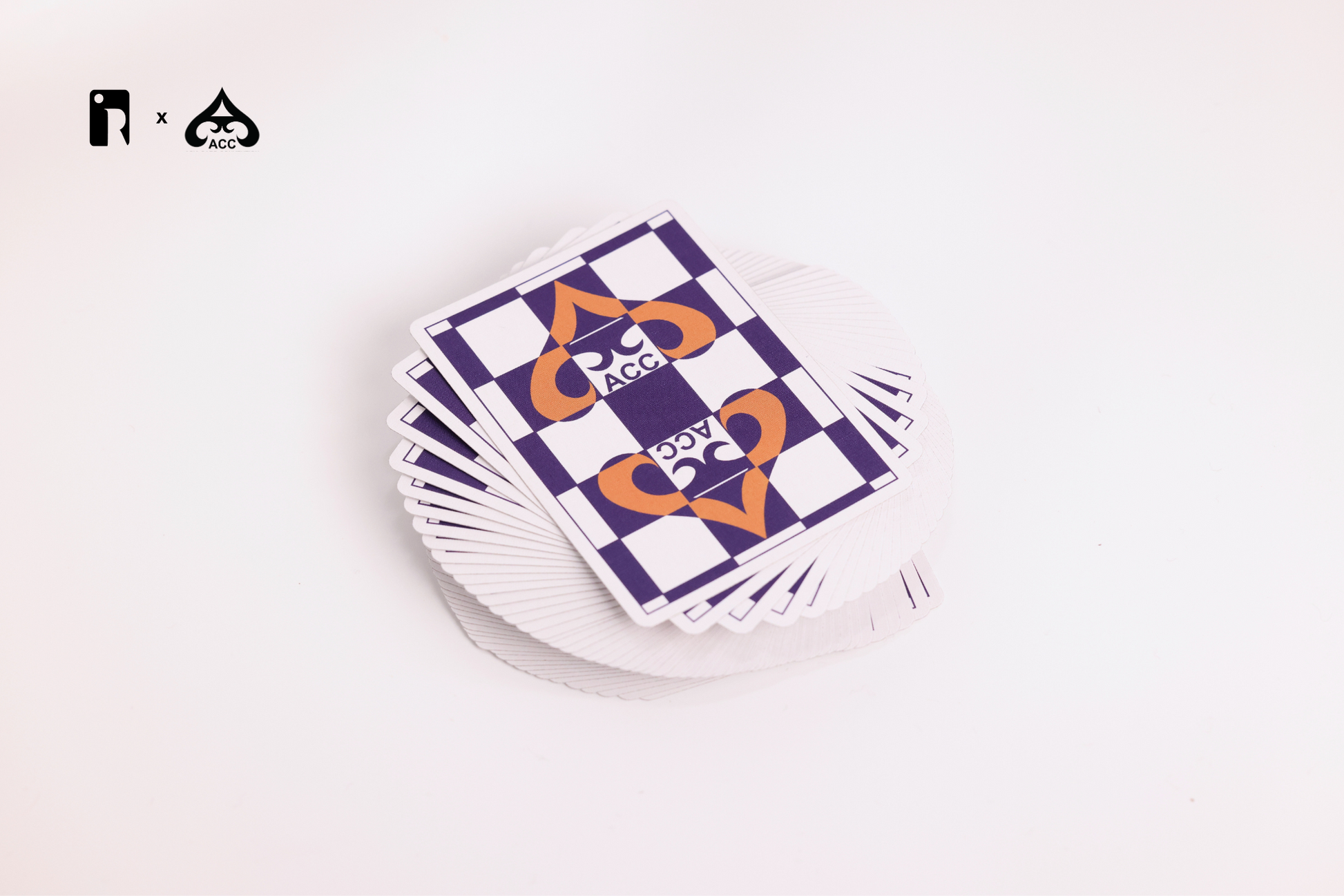 Stack of playing cards with a checkered design on a white surface