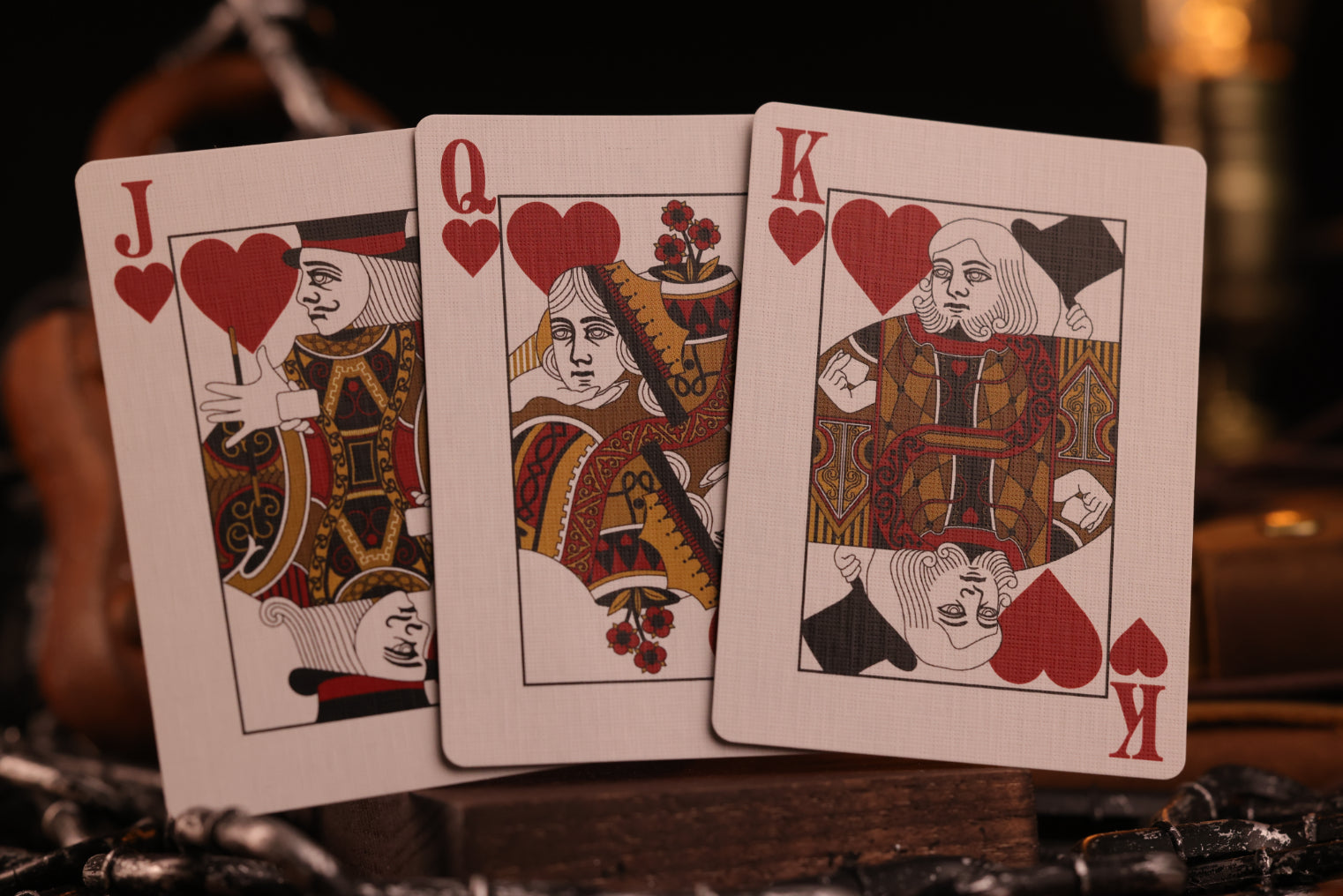 Diamonds Ediiton Court Cards (Jack, Queen, King of Hearts) on a dark background