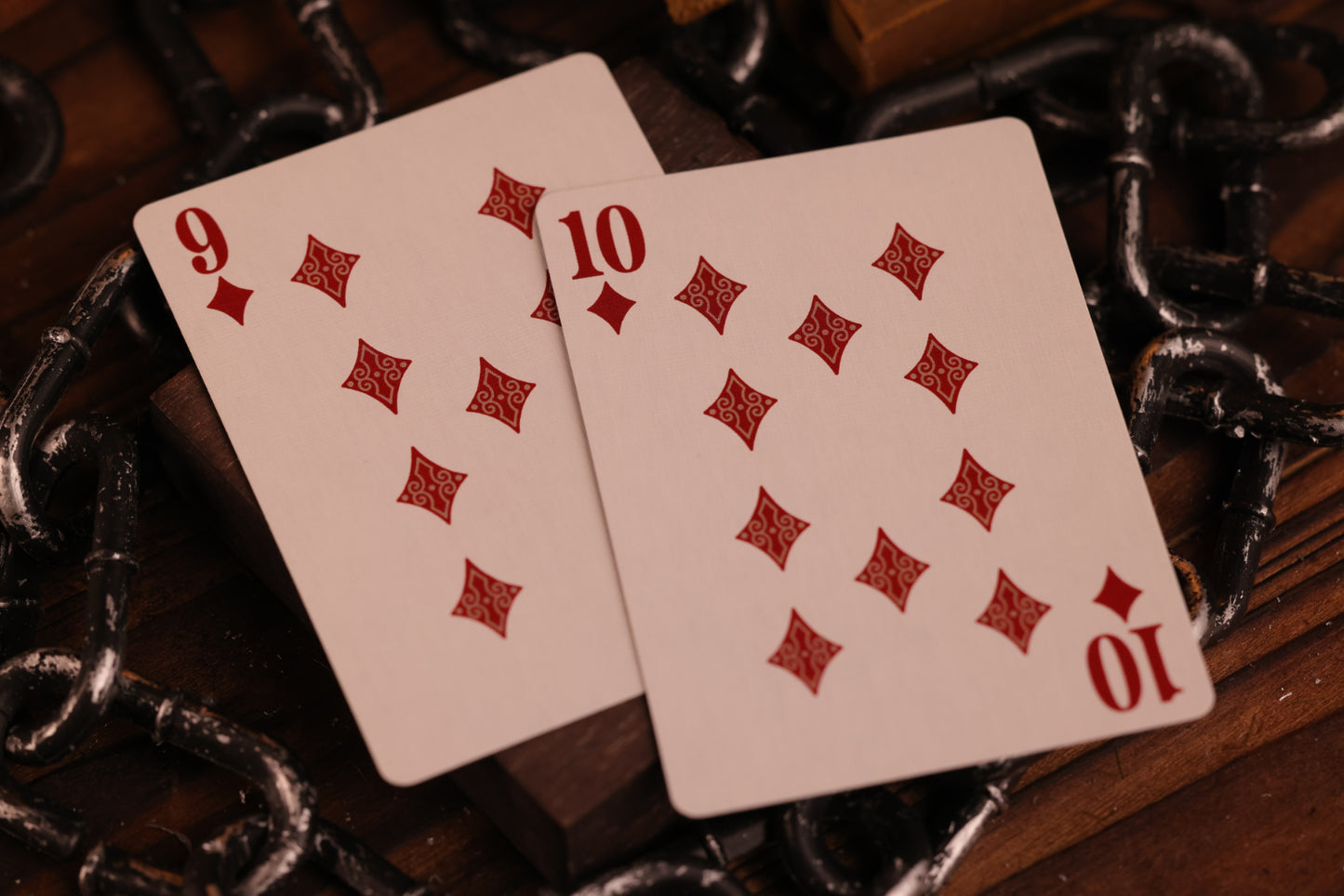 Diamonds Edition Number cards, the 9 of Diamonds and the 10 of Diamonds, on a dark background with chains.