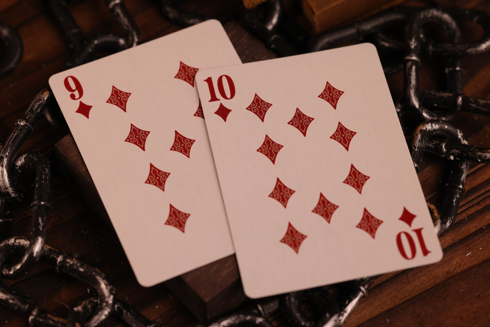 Diamonds Edition Number cards, the 9 of Diamonds and the 10 of Diamonds, on a dark background with chains.