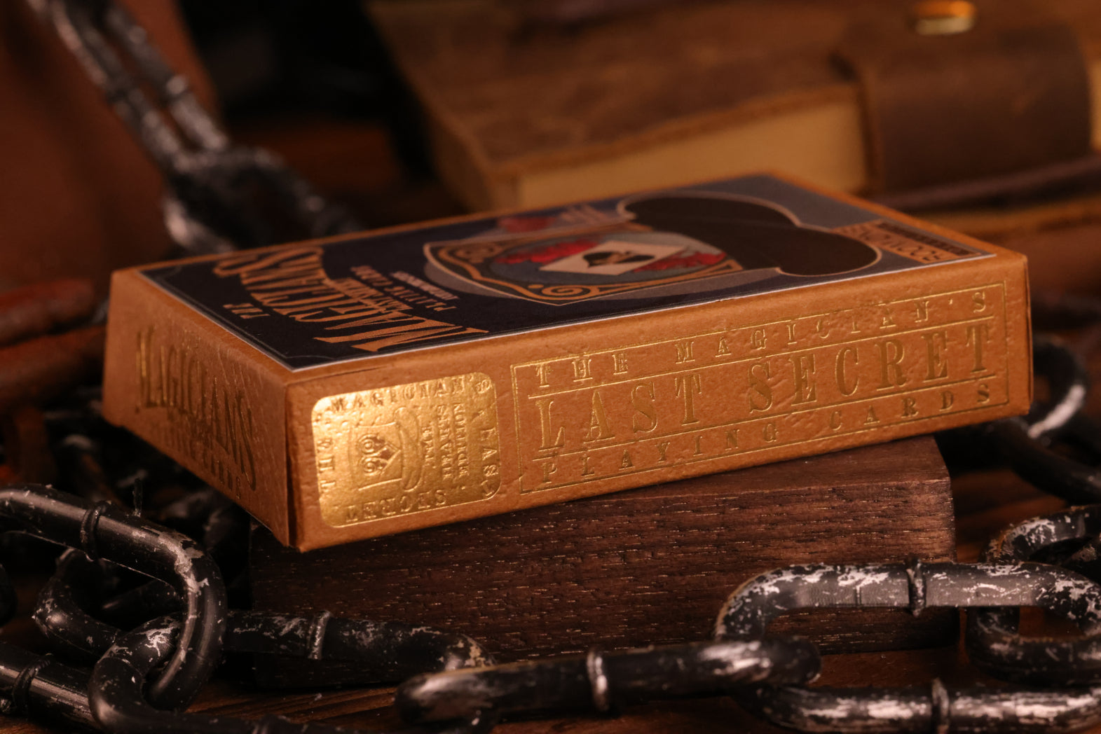 Hearts edition tuck box with intricate designs on a wooden surface with chains.