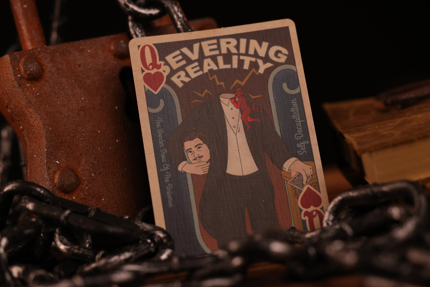 Court card with a magician and text 'Severing Reality' surrounded by dark, textured objects.