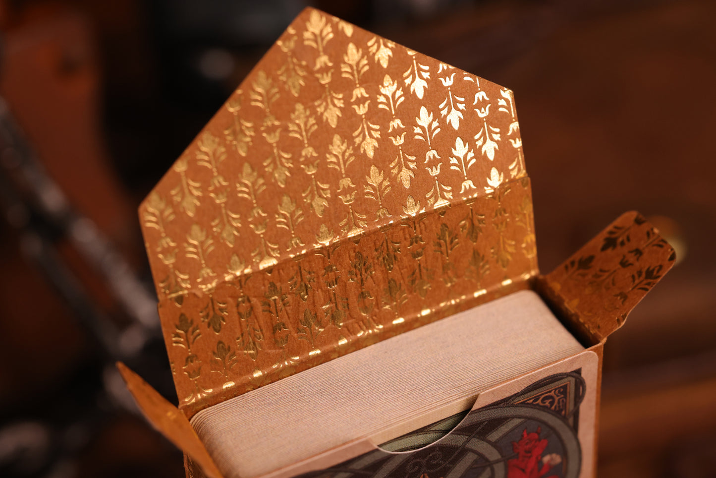 Hearts Edition tuck box interior featuring an intricate gold hot foil design