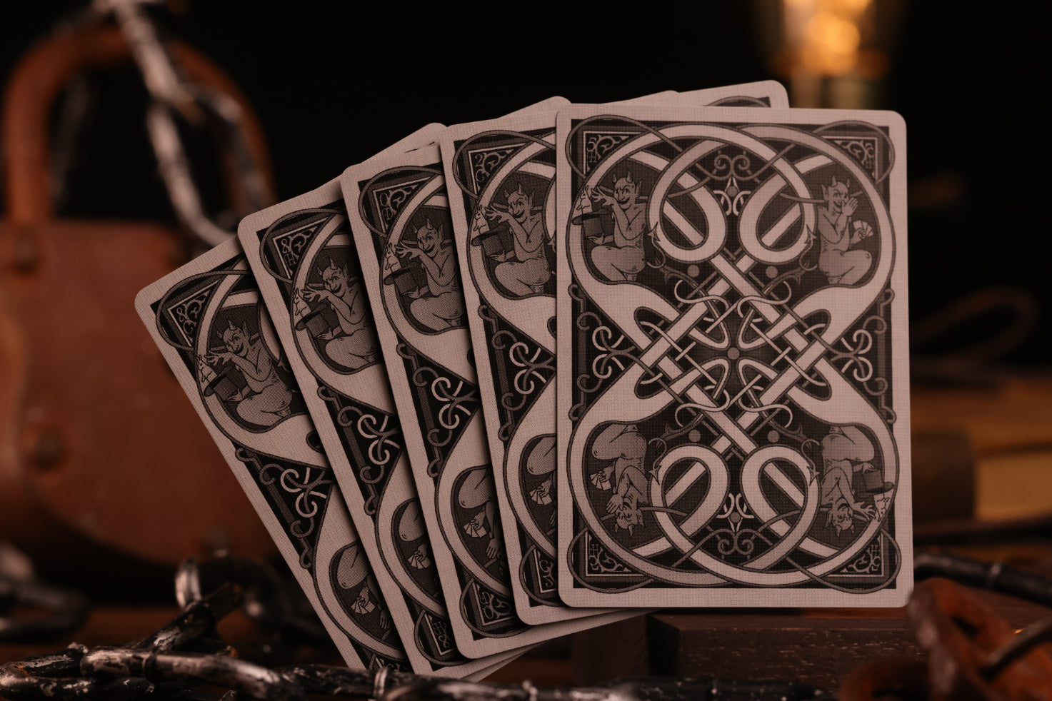 Clubs Edition playing card card backs with intricate designs on a dark background