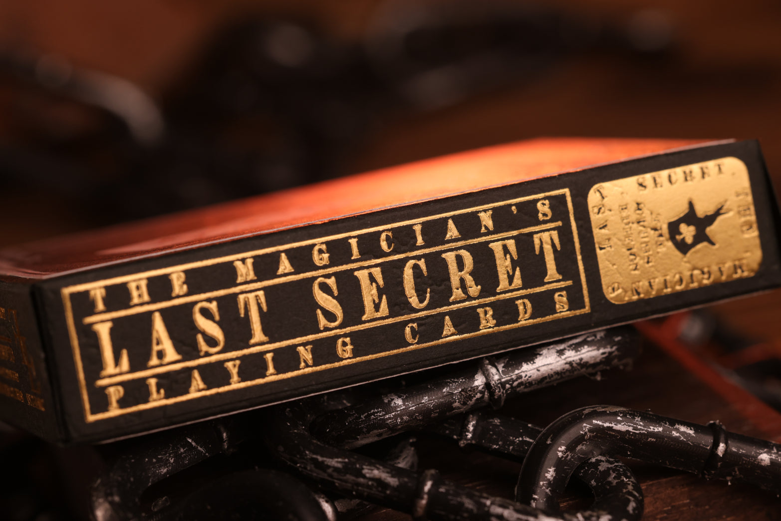 Clubs edition tuck box of 'The Magician's Last Secret Playing Cards' with gold text on a dark background