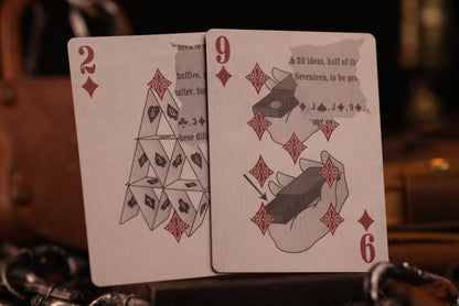 Two number cards with playing card and card magic designs on a blurred background