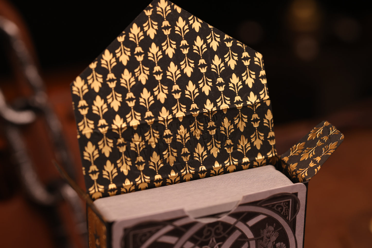 Clubs edition tuck box interior featuring a hot foil gold floral pattern on a dark background