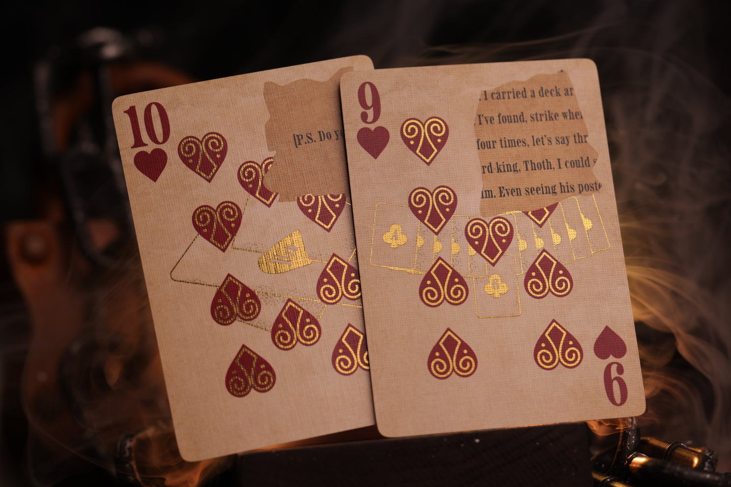 Two number cards with metallic gold cold foil detailing on a dark background