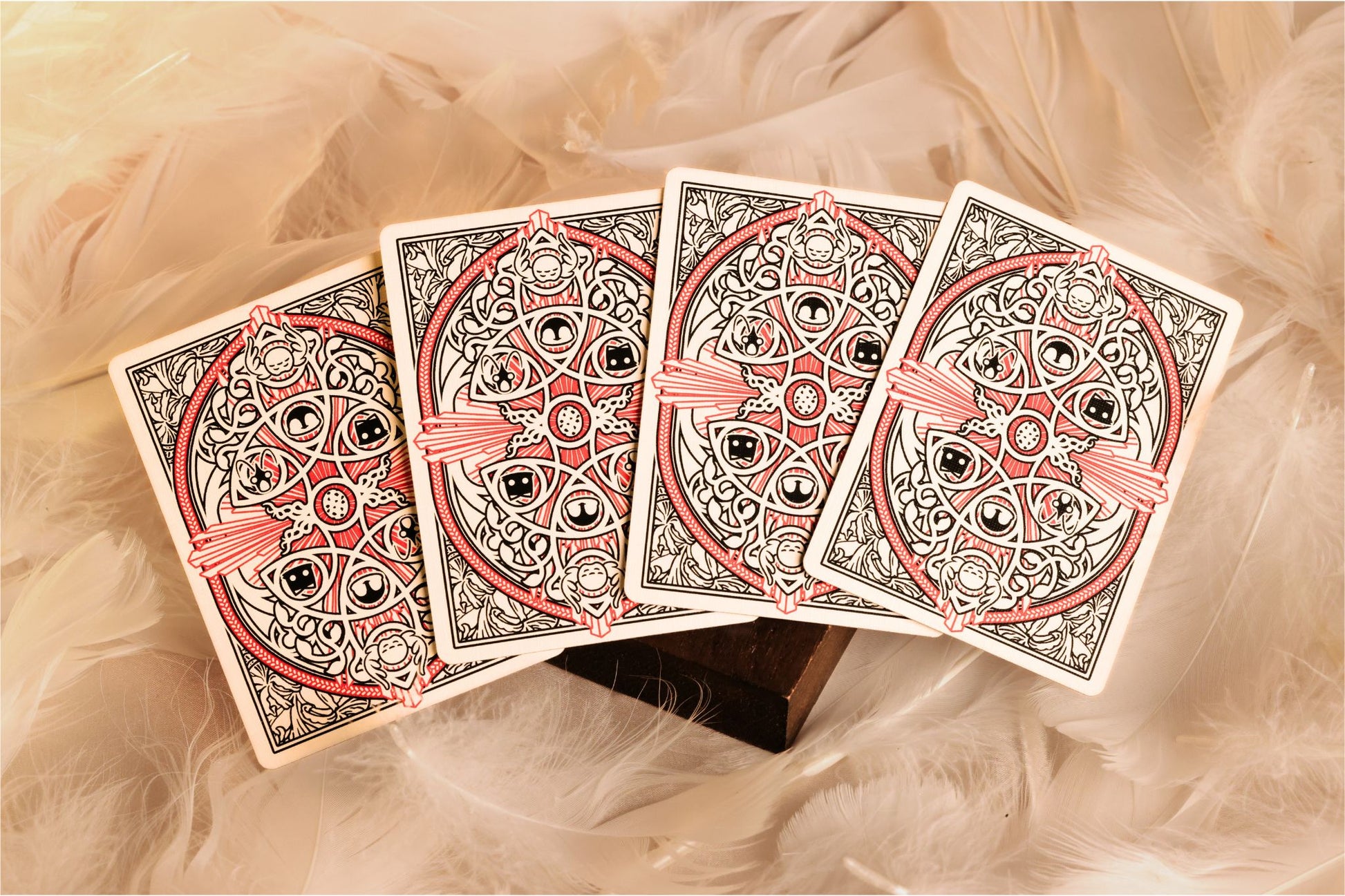 MYTHIC edition Fury of Light cards with decorative design on a bed of feathers, text indicating a change in the final production's color scheme.