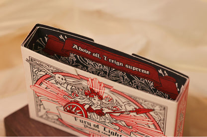 MYTHIC edition Fury of Light tuck box interior with intricate illustrated design on a bed of feathers.