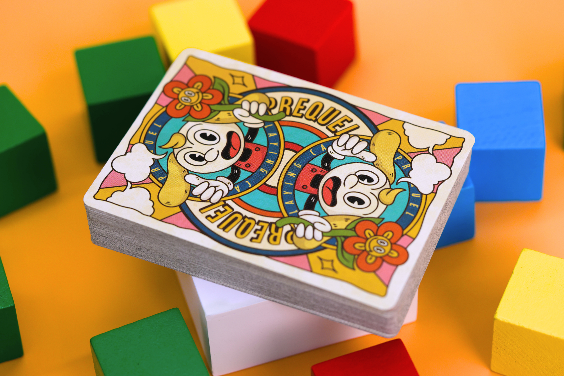 Prequel Classic Edition Card backs featuring colorful cards with cartoon character design on a bright orange background with colorful blocks.